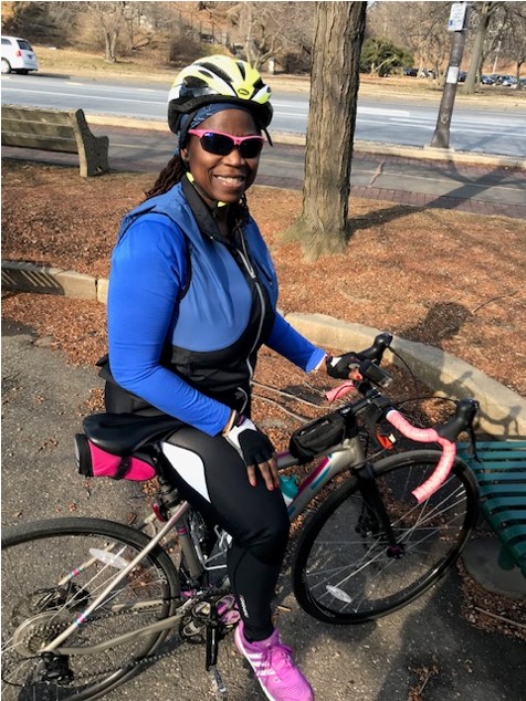 Stephanie posing with her bike in all her riding gear.