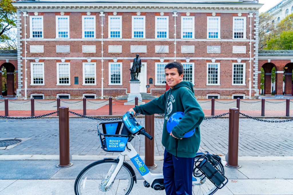Man with Indego bike sightseeing at Independence Hall